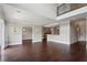 Large open-concept living room with dark wood floors, recessed lighting, and neutral walls at 3280 Stillhouse Se Ln # 401, Atlanta, GA 30339