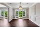 Living room area featuring chandelier lighting, door to patio and wood floor at 3280 Stillhouse Se Ln # 401, Atlanta, GA 30339