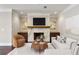 Cozy living room features a marble fireplace, custom cabinets, and comfortable seating at 3280 Stillhouse Se Ln # 401, Atlanta, GA 30339