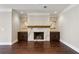 Spacious living room features a marble fireplace with custom cabinets, and stained wood floor at 3280 Stillhouse Se Ln # 401, Atlanta, GA 30339