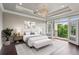 Bright bedroom with hardwood floors, balcony access, and decorative lighting at 3280 Stillhouse Se Ln # 401, Atlanta, GA 30339