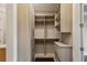 Spacious walk-in closet with built-in shelving and drawers at 3280 Stillhouse Se Ln # 401, Atlanta, GA 30339