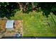 Aerial view of a backyard featuring a shed, swing set, garden boxes, and small seating area at 3425 Poplar Dr, Lawrenceville, GA 30044