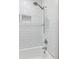 Bright bathroom featuring a white tiled shower with a shower niche at 3425 Poplar Dr, Lawrenceville, GA 30044