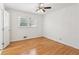 Bright bedroom with wood floors, white walls, ceiling fan, and natural light at 3425 Poplar Dr, Lawrenceville, GA 30044