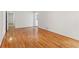 Bright, empty room featuring recently refinished hardwood floors and freshly painted white walls with clean trim at 3425 Poplar Dr, Lawrenceville, GA 30044