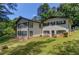 Classic home featuring a well-maintained lawn, dark trim, and ample natural light through numerous windows at 3425 Poplar Dr, Lawrenceville, GA 30044