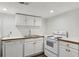 Bright kitchen featuring white cabinets and appliances for a clean, functional space at 3425 Poplar Dr, Lawrenceville, GA 30044