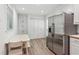 Eat-in kitchen features a stainless steel refrigerator, pantry, and wood-look flooring at 3425 Poplar Dr, Lawrenceville, GA 30044