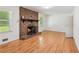 Living room showcasing a brick fireplace with wood mantle and hardwood floors at 3425 Poplar Dr, Lawrenceville, GA 30044