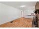 Spacious living room with hardwood floors adjacent to a fireplace and opening to the kitchen at 3425 Poplar Dr, Lawrenceville, GA 30044
