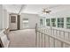 Sun-drenched living room featuring neutral carpet, brick accents, modern ceiling fan and expansive windows at 3425 Poplar Dr, Lawrenceville, GA 30044