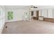 Expansive living room with soft neutral carpet, brick accents, and ample natural light through many windows at 3425 Poplar Dr, Lawrenceville, GA 30044