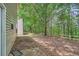 This backyard offers a patio, wooded area, and a wooden fence at 7078 Ravenwood Ln, Lithonia, GA 30038