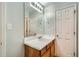 This bathroom offers a sink with storage, large mirror, and vanity lighting at 7078 Ravenwood Ln, Lithonia, GA 30038
