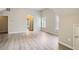 Spacious bedroom with wood floors, a hallway bathroom, and natural light at 7078 Ravenwood Ln, Lithonia, GA 30038