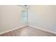 Cozy bedroom featuring wood floors, neutral paint, and natural light at 7078 Ravenwood Ln, Lithonia, GA 30038