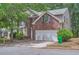 Inviting two-story home with a brick facade, attached garage, and landscaped front yard at 7078 Ravenwood Ln, Lithonia, GA 30038