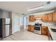 Kitchen featuring stainless steel appliances, wooden cabinets, and light countertops at 7078 Ravenwood Ln, Lithonia, GA 30038