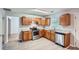 A kitchen with stainless steel appliances, wooden cabinets, and light countertops at 7078 Ravenwood Ln, Lithonia, GA 30038