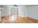 Spacious living room with hardwood floors, bay windows, and a decorative fireplace at 7078 Ravenwood Ln, Lithonia, GA 30038