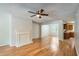 Open-concept living room featuring hardwood floors, a fireplace, and an adjacent kitchen at 7078 Ravenwood Ln, Lithonia, GA 30038