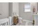 Cozy bathroom featuring white fixtures, a wooden cabinet, and a window allowing natural light to illuminate at 1039 Fern Se Ave, Atlanta, GA 30315