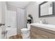 Bright bathroom featuring a tub, patterned shower curtain, wood-look vanity, and decorative accents at 1039 Fern Se Ave, Atlanta, GA 30315