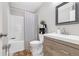 Well-lit bathroom featuring modern sink, cabinets, and shower with patterned curtain at 1039 Fern Se Ave, Atlanta, GA 30315