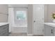 Bright bathroom features a tub and shower, window, and gray vanity at 1039 Fern Se Ave, Atlanta, GA 30315