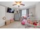 bedroom with lots of stuffed animals, a ceiling fan, soft carpet, and a large window at 1039 Fern Se Ave, Atlanta, GA 30315