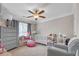 Bedroom for a features a gray dresser, soft carpet, and a large window at 1039 Fern Se Ave, Atlanta, GA 30315