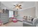 Charming Bedroom with a crib, dresser, and cozy seating area, designed for comfort and functionality at 1039 Fern Se Ave, Atlanta, GA 30315
