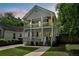 Charming two-story home featuring double porches, well-manicured lawn and walkway leading to the front entrance at 1039 Fern Se Ave, Atlanta, GA 30315