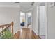 Upstairs hallway with hardwood flooring, view into living areas, and access to bedrooms at 1039 Fern Se Ave, Atlanta, GA 30315