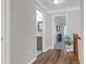 Bright hallway with hardwood floors leading to a bathroom and bedroom at 1039 Fern Se Ave, Atlanta, GA 30315