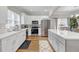 Bright, modern kitchen with stainless steel appliances and white cabinets, complemented by wood flooring and quartz countertops at 1039 Fern Se Ave, Atlanta, GA 30315
