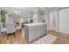Open kitchen with a gray island, hardwood floors, and views into the living and dining areas at 1039 Fern Se Ave, Atlanta, GA 30315