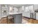 Modern kitchen featuring white cabinets, stainless steel appliances, a gray center island with bar seating at 1039 Fern Se Ave, Atlanta, GA 30315