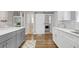 Charming kitchen showcasing white cabinets, grey island, stainless steel appliances, and barn door to laundry at 1039 Fern Se Ave, Atlanta, GA 30315
