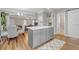 Open concept kitchen area with a gray island, leading to a living room and dining area for seamless entertaining at 1039 Fern Se Ave, Atlanta, GA 30315