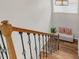 Bright staircase landing with wood floors, iron railing and a cozy bench beneath a window, enhancing the home's charm at 1039 Fern Se Ave, Atlanta, GA 30315
