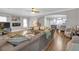 Spacious living room features hardwood floors, comfortable sectional seating, archway to kitchen, and neutral paint at 1039 Fern Se Ave, Atlanta, GA 30315
