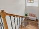 Staircase with wood and iron railing leading to a bench seat with pillows near a window at 1039 Fern Se Ave, Atlanta, GA 30315