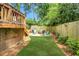Serene backyard featuring a fire pit with Adirondack chairs and lush landscaping at 114 Karland Nw Dr, Atlanta, GA 30305