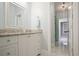 Bright bathroom with granite countertop, white cabinets, and marble flooring; view to connecting rooms at 114 Karland Nw Dr, Atlanta, GA 30305