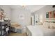 Cozy bedroom with soft gray walls, white furniture, patterned chair, and bright natural light at 114 Karland Nw Dr, Atlanta, GA 30305