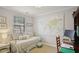 Cozy bedroom features daybed, neutral paint, natural light, and hardwood floors at 114 Karland Nw Dr, Atlanta, GA 30305