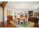 Expansive living room featuring hardwood floors, dining area, exposed wood beams, fireplace, and comfortable seating at 114 Karland Nw Dr, Atlanta, GA 30305
