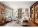 Bright and airy living room featuring a brick accent wall and an elegant display cabinet at 114 Karland Nw Dr, Atlanta, GA 30305